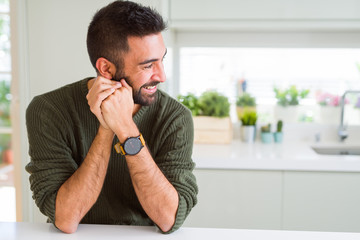 Handsome man smiling cheerful with a big smile on face showing teeth, positive and happy expression