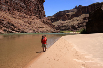 Wall Mural - Young woman enjoying the beach above Hance Rapids on the Colorado River in Grand Canyon National Park, Arizona.