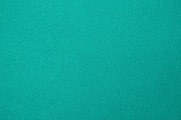 Dense light green fabric texture.Background of bright green fabric.