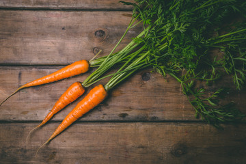 Fresh tasty carrots on a wooden rustic table. Healthy food. Vegetables.