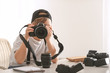 © Pixel-Shot - Cute little photographer with professional camera at home