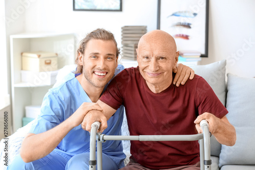 Photographie Elderly man with caregiver in nursing home
