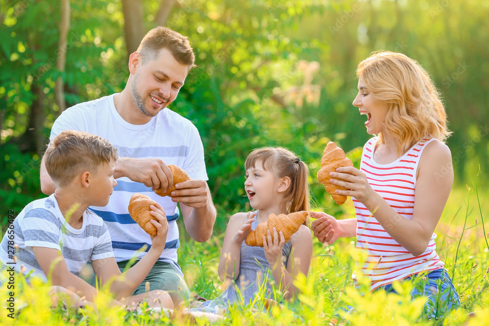 Happy family on summer picnic in park