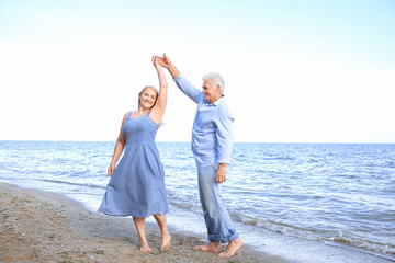 Sticker - Happy mature couple dancing at sea resort