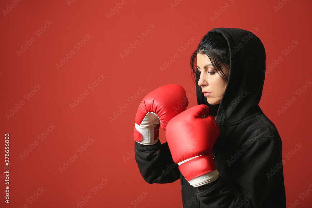 Sporty female boxer on color background