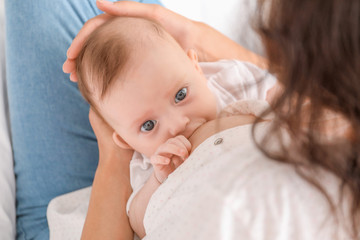 Canvas Print - Young woman breastfeeding her baby at home