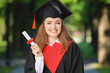 © Pixel-Shot - Happy young woman with diploma on graduation day
