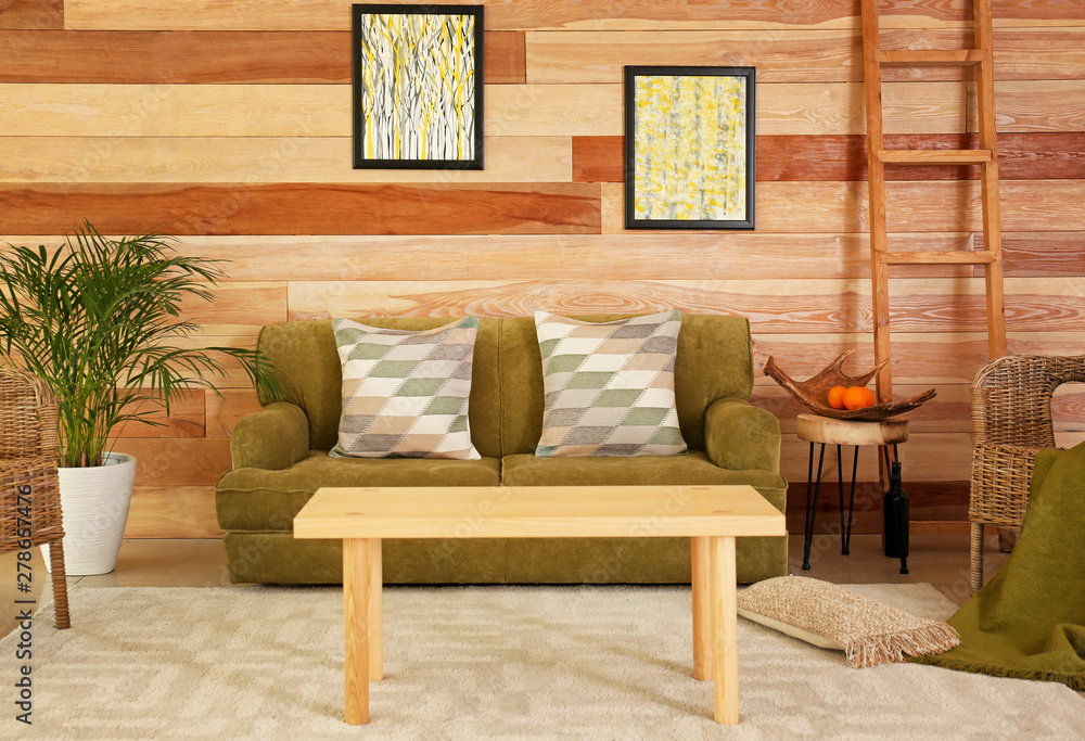 Stylish interior of room with soft sofa and pillows