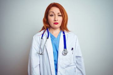 Sticker - Young redhead doctor woman using stethoscope over white isolated background looking sleepy and tired, exhausted for fatigue and hangover, lazy eyes in the morning.