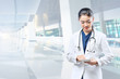 © Leo Lintang - Asian woman doctor in white lab coat and stethoscope using tablet