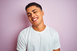 © Krakenimages.com - Young brazilian man wearing t-shirt standing over isolated pink background with a happy face standing and smiling with a confident smile showing teeth