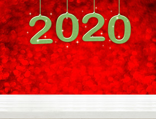 Poster - 2020 happy new year green wood number (3d rendering) on white wood table with sparkling red bokeh wall,leave space for display or montage of design or content of christmas or new year eve.