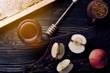 © alefat - Honey background. Sweet honey in the comb, glass jar. On wooden background.