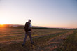 © robcartorres - backpacker traveler walking at sunrise