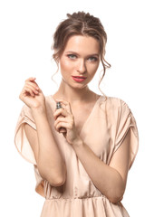 Wall Mural - Beautiful young woman with bottle of perfume on white background