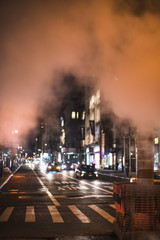 View of busy night road in smoke