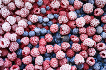 Fototapete - Background of frozen berries. Top view of raspberries and blueberries.