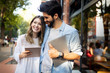 © NDABCREATIVITY - Young couple using a digital tablet together and smiling