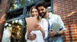 © NDABCREATIVITY - Travel, vacation, technology and friendship concept. Smiling couple with tablet in city