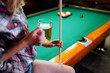 © NDABCREATIVITY - Young smiling girl playing billiard in club