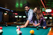 © NDABCREATIVITY - Couple drinking beer and playing snooker on date