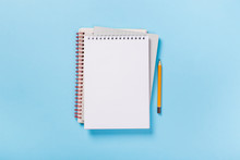 School Notebook On A Blue Background, Spiral Notepad On A Table