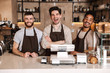 © Drobot Dean - Group of cheerful men baristas wearing aprons