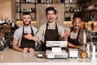 © Drobot Dean - Happy coffee men colleagues in cafe bar working indoors.