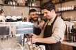 © Drobot Dean - Group of cheerful men baristas wearing aprons