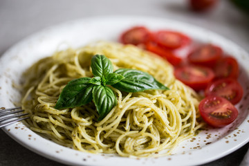 Wall Mural - Spaghetti with homemade pesto sauce, basil leaves and  tomatoes/