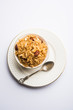 © Arundhati - Traditional Jaggery Rice or Gur wale chawal in Hindi, served in a bowl with spoon. selective focus