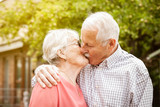 Fototapeta  - elderly senior couple kiss each other