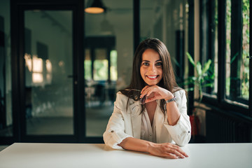 Wall Mural - Portrait of a elegant positive businesswoman at modern office.