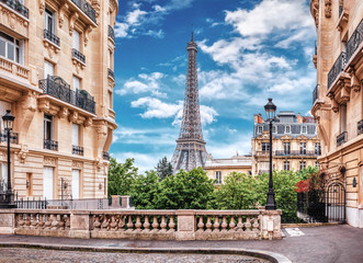 Small Paris street with view on the famous Eiffel Tower in Paris, France.