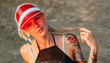 © Artem Markin - Beautiful blonde in a red transparent visor. Portrait on the beach. Travel in Thailand.