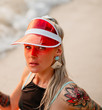 © Artem Markin - Beautiful blonde in a red transparent visor. Portrait on the beach. Travel in Thailand.