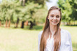 © LIGHTFIELD STUDIOS - selective focus of beautiful smiling woman in park looking at camera