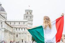 Young Teen Girl Traveler With Italian Flag Before The Historic Tower In Town Pisa - Italy