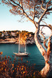 Luxury sail yacht is the best way to travel and spend time at the sea. Sunset view of a bay with warm color tones. Cala Portals Vells, Mallorca. Balearic Islands