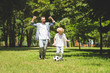 © LIGHTFIELD STUDIOS - excited father and adorable son playing football in park