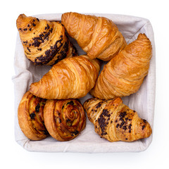 Wall Mural - Plain and chocholate croissants and rasin danish pastry swirls in linen basket isolated on white from above.