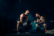 © zamuruev - Two muscular bearded tattoed athletes training, one lift heavy weight bar when other is motivating. Scream. Working hard. Exercise for the muscles of the back