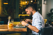 man having breakfast or dinner in cafe