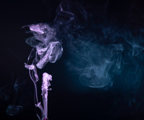 Wall Mural - Abstract colorful smoke on black background .