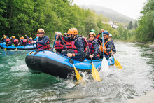 Group Of People Rafting In Rubber Dinghy On A River