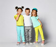 © FAB.1 - shot of three children in bright clothes, two girls and one boy. Triplets, brother and sisters.