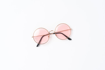 Round sunglasses on white background. Flat lay