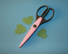 Pink Scrapbooking Scissors, Decorative Contour Pattern, Three Green Hearts Cut Out Of Colored Paper