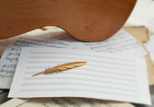 Musical Conceptual Composition Of Wooden Gi Macaw, A Symbol Of The Golden Birds Of A Feather Lying On A Background Of Music And Old Yellowed Paper