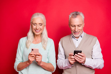 Wall Mural - Close up photo beautiful she her he him his aged white hair guy lady partners hold hands arms telephones texting children modern parents wear sweater shirt waistcoat isolated red burgundy background